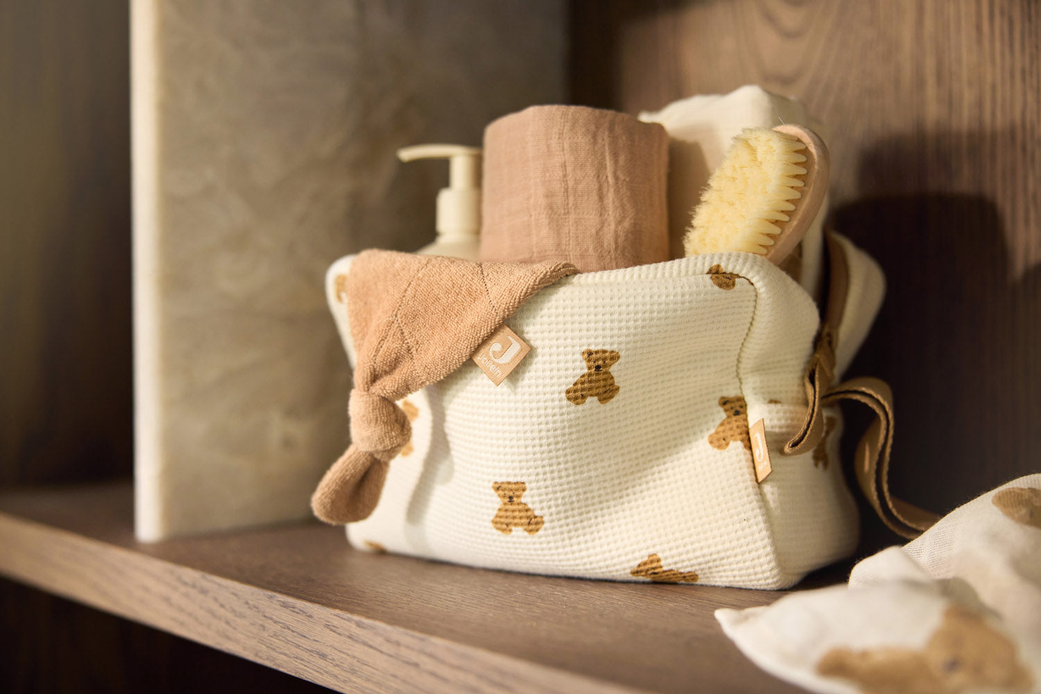 Jollein Little Waffle Mini Teddy Bear pouch holding care essentials on a shelf