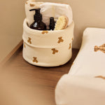 Jollein Little Waffle Mini Teddy Bear changing table basket beside a Teddy Bear changing-pad cover
