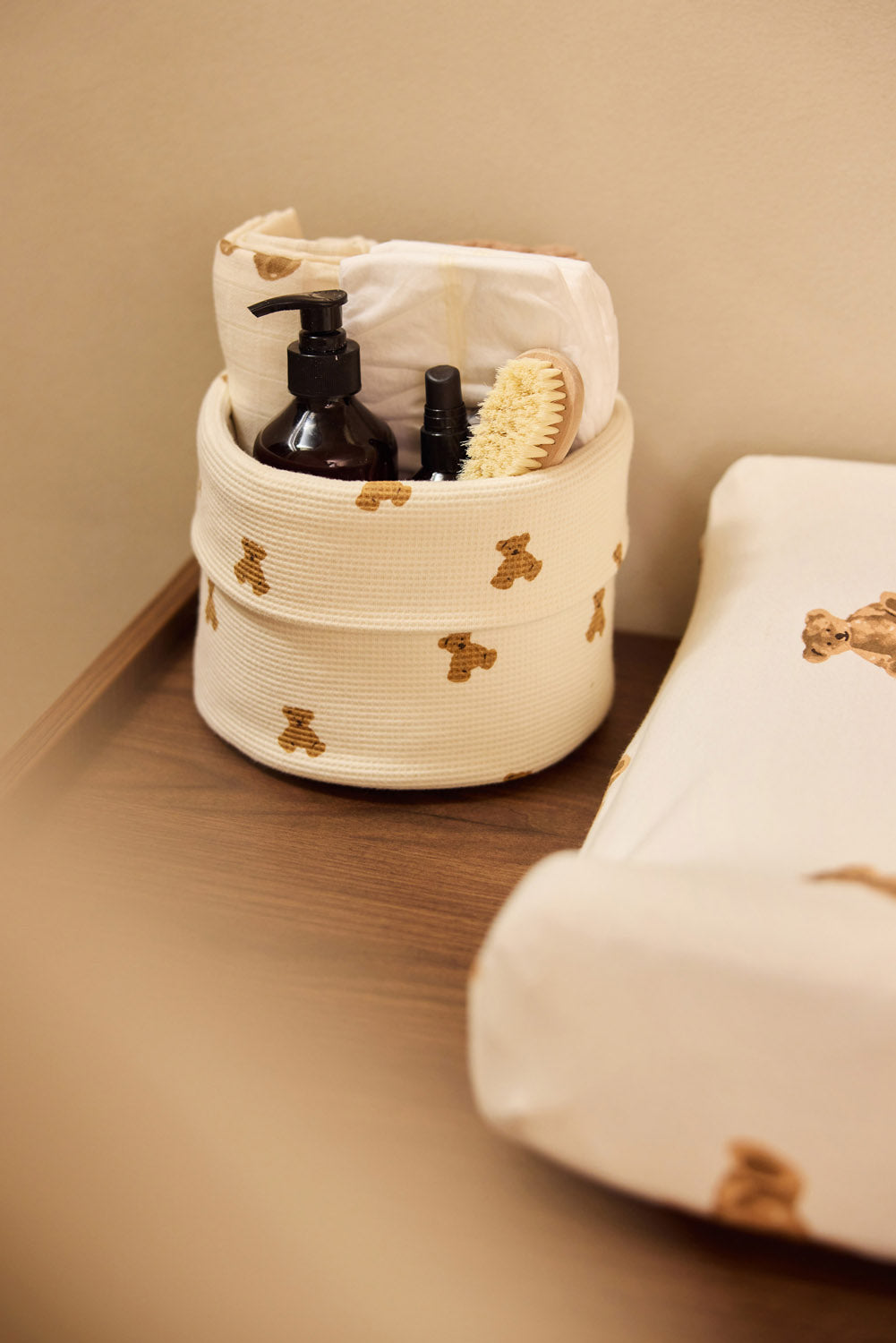 Jollein Little Waffle Mini Teddy Bear changing table basket beside a Teddy Bear changing-pad cover