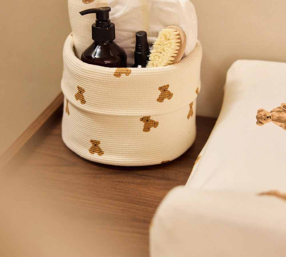 Jollein Little Waffle Mini Teddy Bear changing table basket beside a Teddy Bear changing-pad cover
