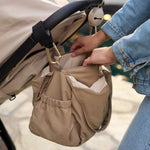 Jollein Urban diaper bag in Earthy attached to a stroller with Milky Coffee stroller hooks