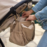 Jollein Urban diaper bag in Earthy attached to a stroller with Milky Coffee stroller hooks