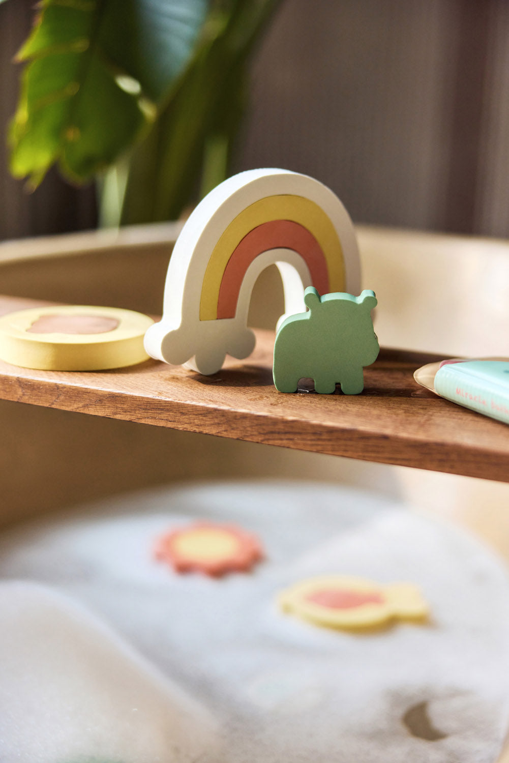 Jollein Kangaroots rainbow and animal bath puzzle pieces displayed on a wooden bath tray