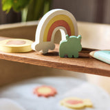 Jollein Kangaroots rainbow and animal bath puzzle pieces displayed on a wooden bath tray