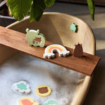 Jollein Kangaroots bath puzzle pieces floating in water and displayed along a wooden bath tray