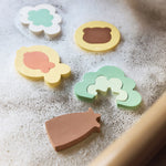 Close-up of colourful Jollein Kangaroots foam bath puzzle pieces on a bath edge