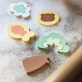 Close-up of colourful Jollein Kangaroots foam bath puzzle pieces on a bath edge