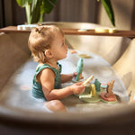 Child playing with the Jollein Kangaroots bath foam playset in a bathtub