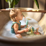 Child playing with the Jollein Kangaroots bath foam playset in a bathtub