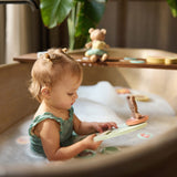 Child holding a figure from the Jollein Kangaroots bath foam playset in a bathtub