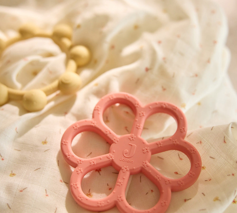 Close-up of the Jollein flower and sun silicone teething rings in Coral Rose and Vanilla