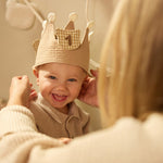 Child wearing the Jollein Teddy Bear birthday crown with number 1 while an adult adjusts it