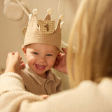 Child wearing the Jollein Teddy Bear birthday crown with number 1 while an adult adjusts it