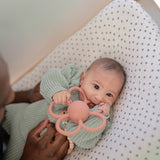 Baby with the Mushie Rattle Teether Daisy