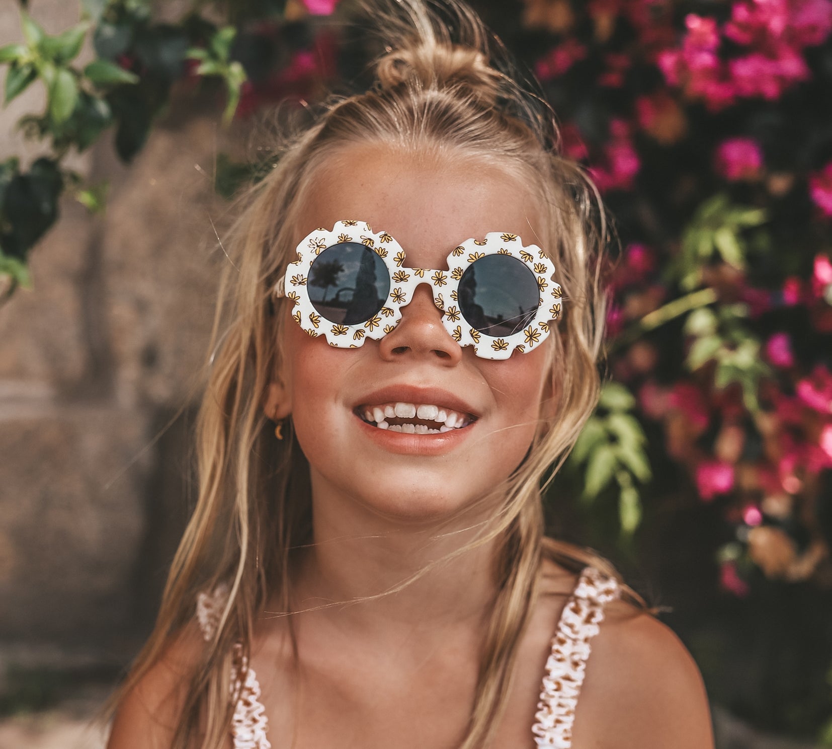 Child wearing Salted Stories Pansy Sierra flower sunglasses in Shortbread lifestyle image
