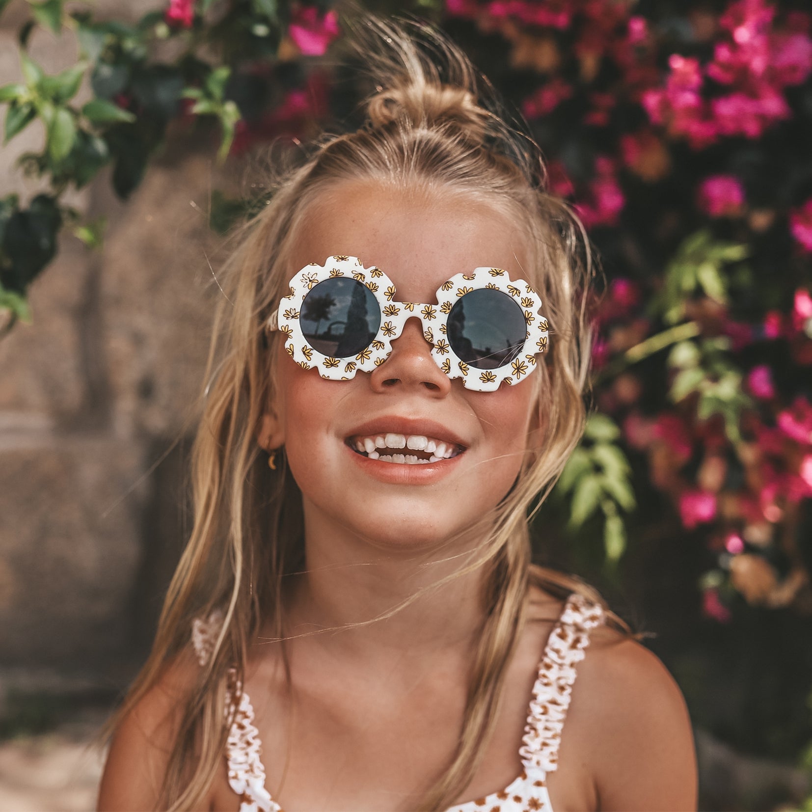 Child wearing Salted Stories Pansy Sierra flower sunglasses in Shortbread lifestyle image