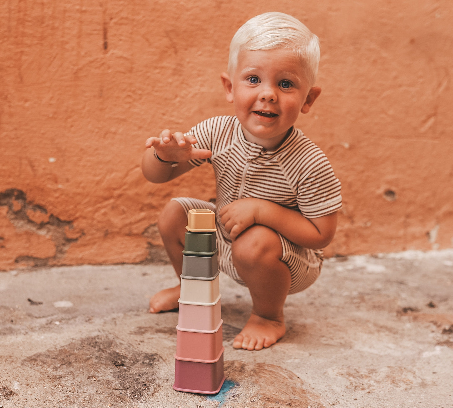 Child playing with Salted Stories Samuel stacking tower multicolour beach toy