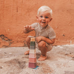 Child playing with Salted Stories Samuel stacking tower multicolour beach toy