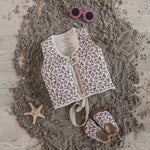 Child wearing Salted Stories Sparkly Flowers floating vest in White Swan