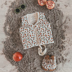 Child wearing Salted Stories Pomegranate floating vest in White Swan