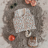Child wearing Salted Stories Pomegranate floating vest in White Swan