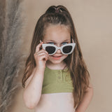 Kids wearing Salted Stories Cat Eye sunglasses in White Swan lifestyle image