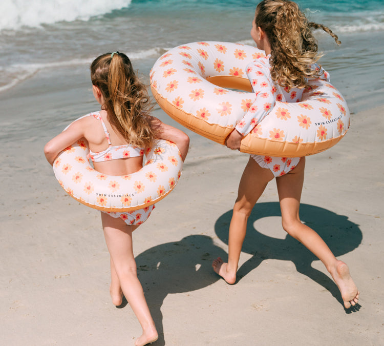 2 girls with Swim Essentials 55cm Swim Ring Flower Hearts 