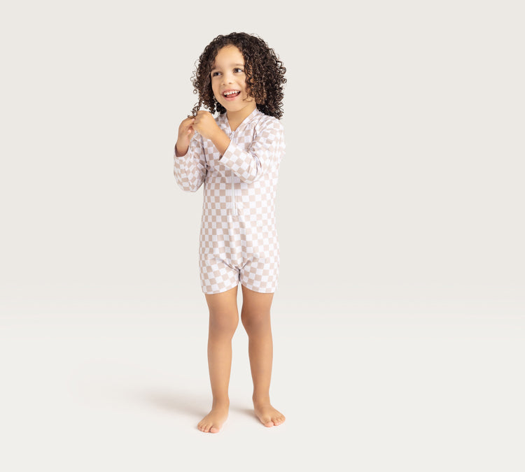 Kid with Swim Essentials Baby Swim Suit Sand Check